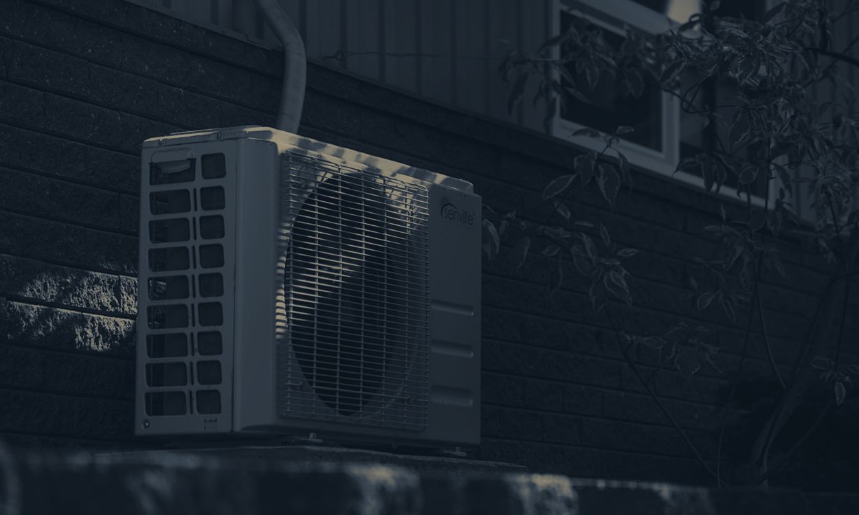 Outdoor HVAC condenser unit mounted beside a home